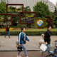 People walk past landscaping set up to mark the upcoming Belt and Road Forum.